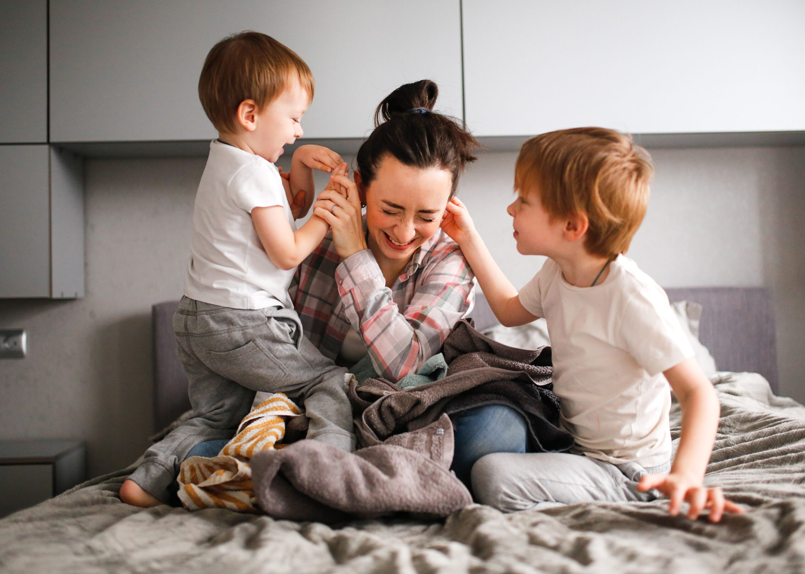 tired mom with two young boys 