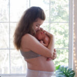 new mom holds newborn baby