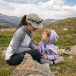 mother with daughter in mountains of colorado