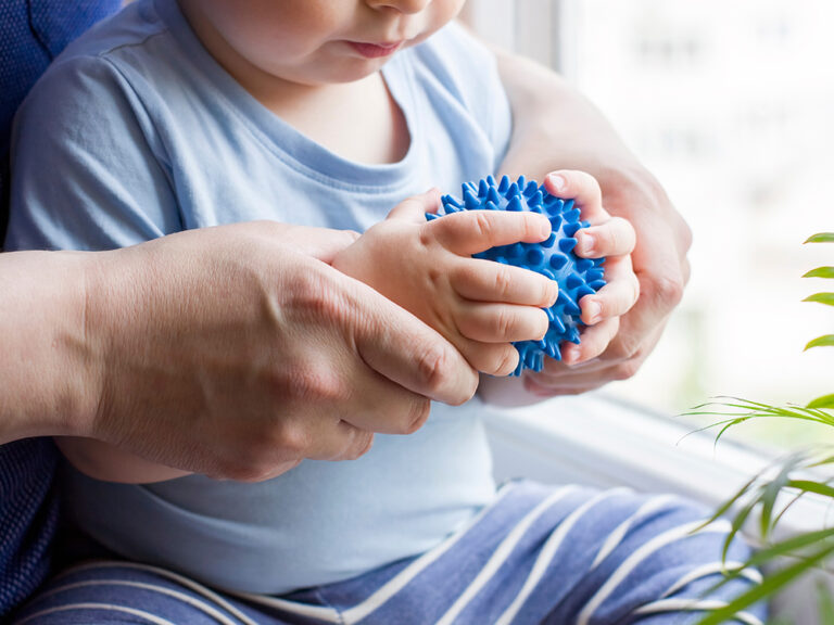 baby playing with sensory ball