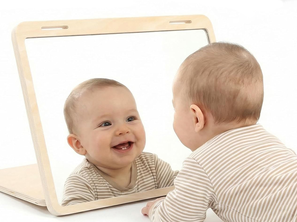 baby looking at floor in mirror 