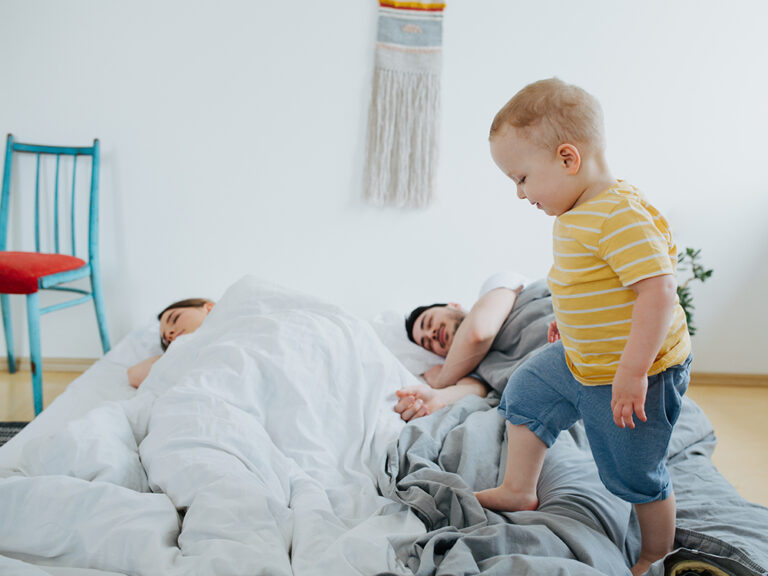 kid trying to wake up sleeping parents