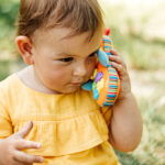 toddler on electronic toy phone