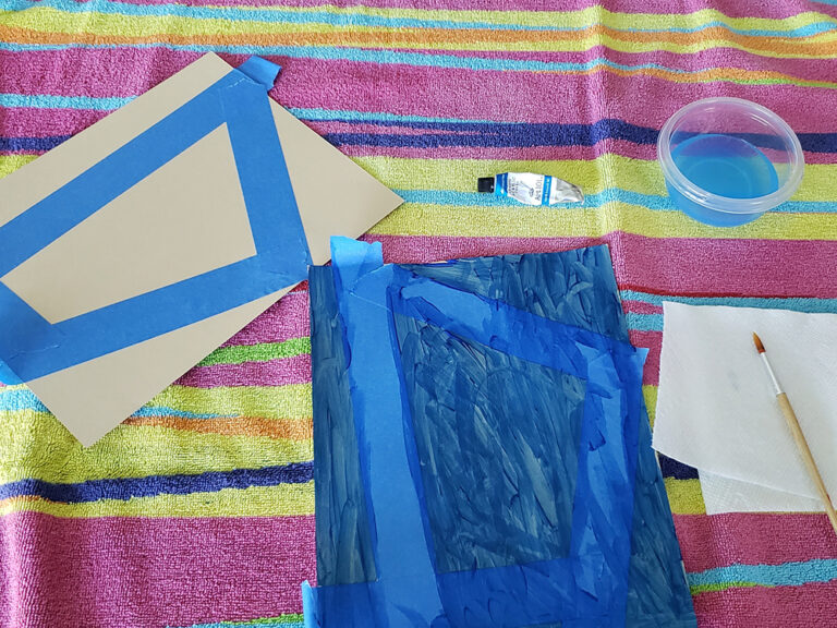 painting over blue tape on top of towel for easy activity
