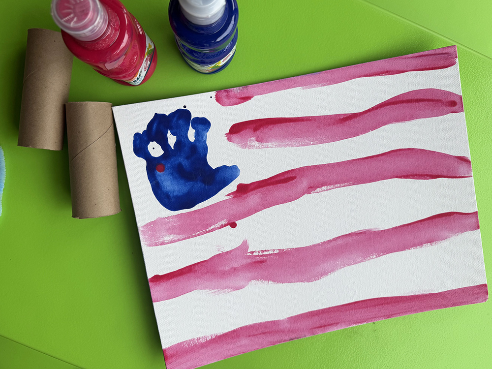 canvas with toddler handprint for stars and white and red stripes to make flag for fourth of july