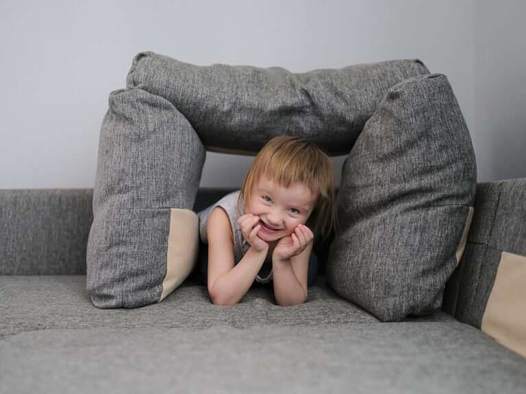 toddler under couch cushions