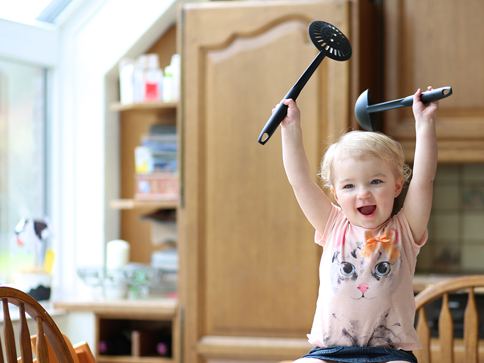 toddler with real kitchen spoons