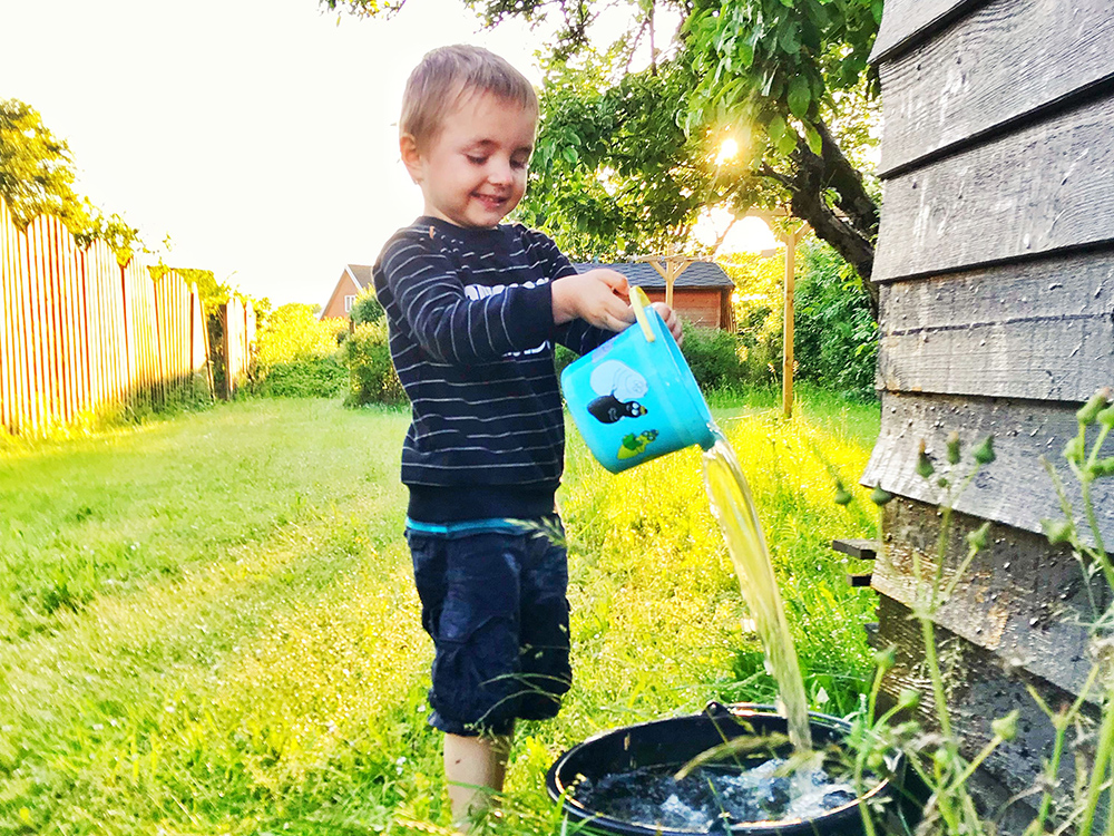 toddler watering bucket outside