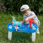 child engages in water play table