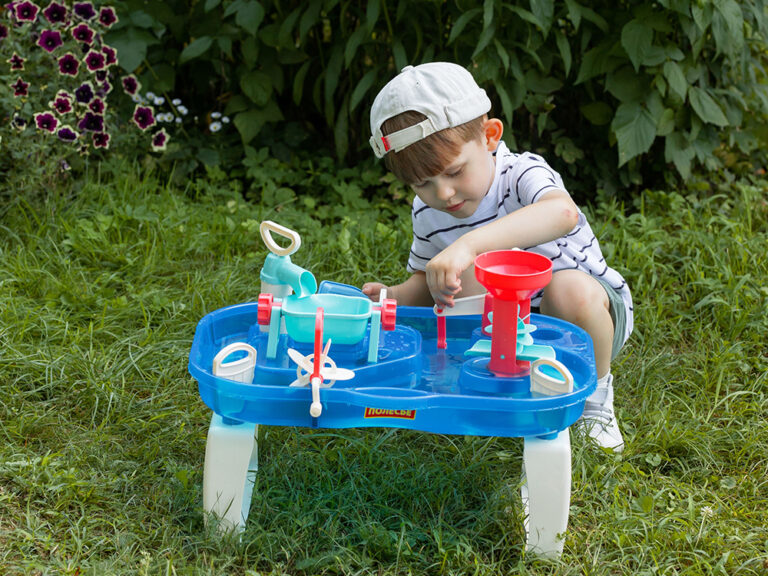 child engages in water play table